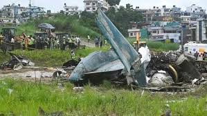 Sole Survivor: Nepal plane crash wreckage with emergency workers attending the scene