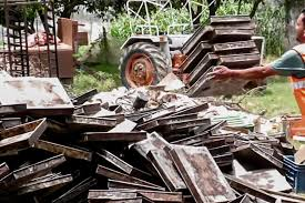 Ayodhya bakery demolition amid heavy police presence, with community members watching.